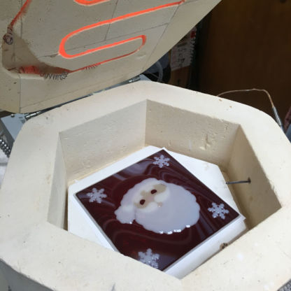 Fused santa cookie tray in kiln being fired