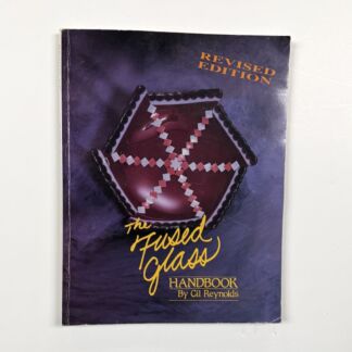 Book cover: 'The Fluxed Glass Handbook' by Gil Reynolds, with 'Revised Edition' in orange, worn purple background.