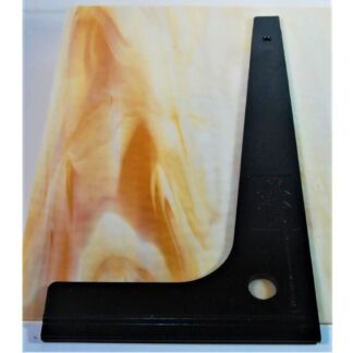 Black metal triangular angle tool (set square) with a circular hole, resting on a light wood surface