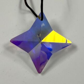 Iridescent four-pointed star pendant in purple and yellow hanging on a black cord