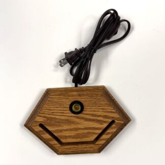 Wooden hexagonal base with a small central light socket and a coiled black power cord attached above it.