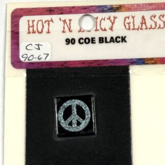 Close-up of a color sample tag reading 'HOT N COLD GLASS' with '90 COE BLACK'; a small black square displays a silver peace symbol.