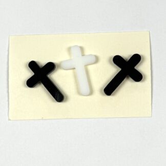 Two black X-shaped crosses flank a white cross on a pale sticky note.