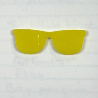 Bright yellow plastic sunglasses with oversized shield-style lenses on a white background, a playful fashion accessory.