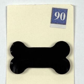Black bone-shaped object mounted on a light beige card with a blue '90' label in the top-right corner.
