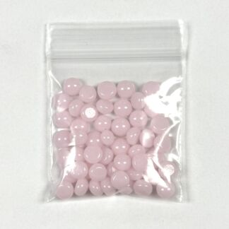 Small pink round tablets in a clear resealable plastic bag.