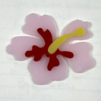 Pink hibiscus with pale petals, red stamen, and a yellow pistil against a light background.