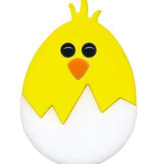 Yellow chick toy with black button eyes and an orange beak peeking from a white broken eggshell.