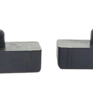 Two identical black rectangular blocks with a circular knob on top, placed side by side on a white background.