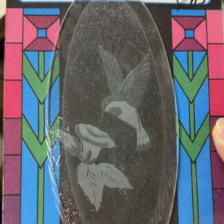 Oval etched glass display featuring a hummingbird and leaves, packaged in a colorful stained-glass style box labeled Designer Glass.