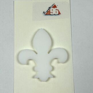 White fleur-de-lis cutout on pale cardstock with a small label at the top.